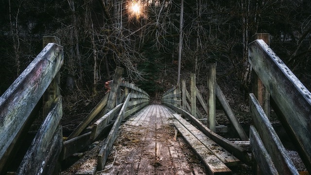 A partially broken wooden bridge